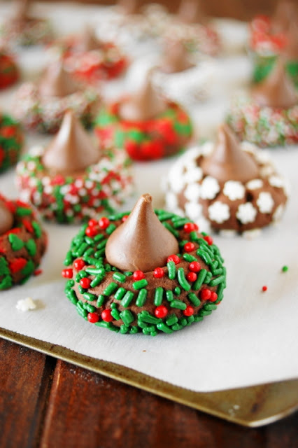 Spread some holiday cheer with these adorable little Christmas Chocolate Kiss Cookies. They're a great cookie project for grown-ups and kids alike because they're just plain fun to make ... and to eat!