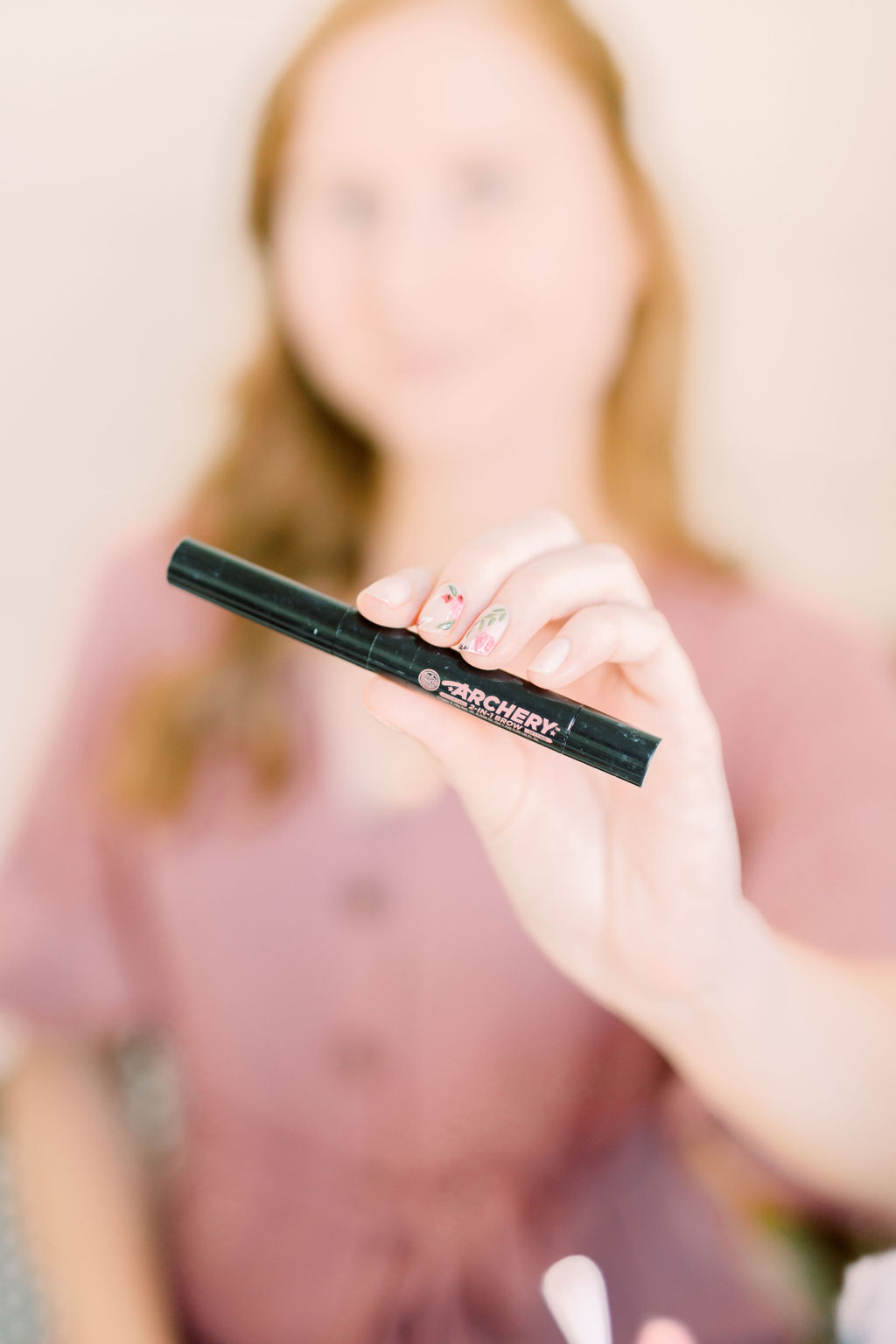 blogger amanda burrows from the fashion blog affordable by amanda is using the $14.00 Soap & Glory Archery 2-in-1 Crayon Gel on her eyebrows