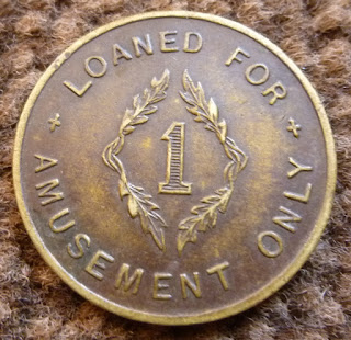A Loaned for Amusement Only, No Value, Property of Machine brass machine token