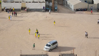 Football is played on a sand field