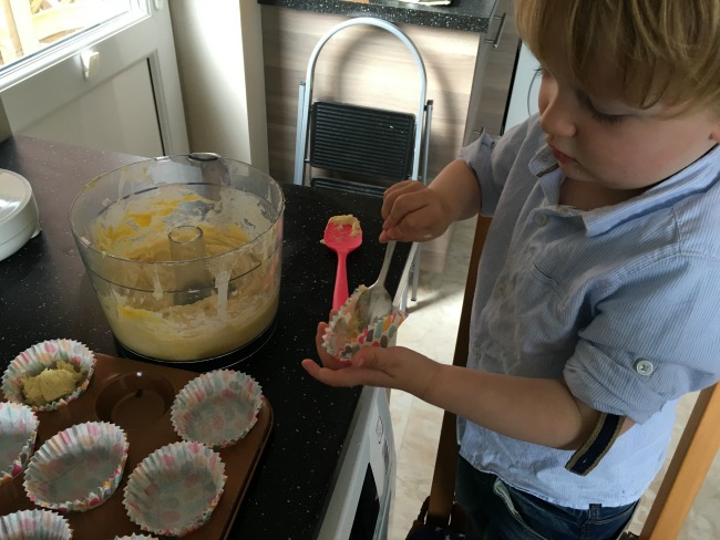 toddler-putting-mixture-into-cases