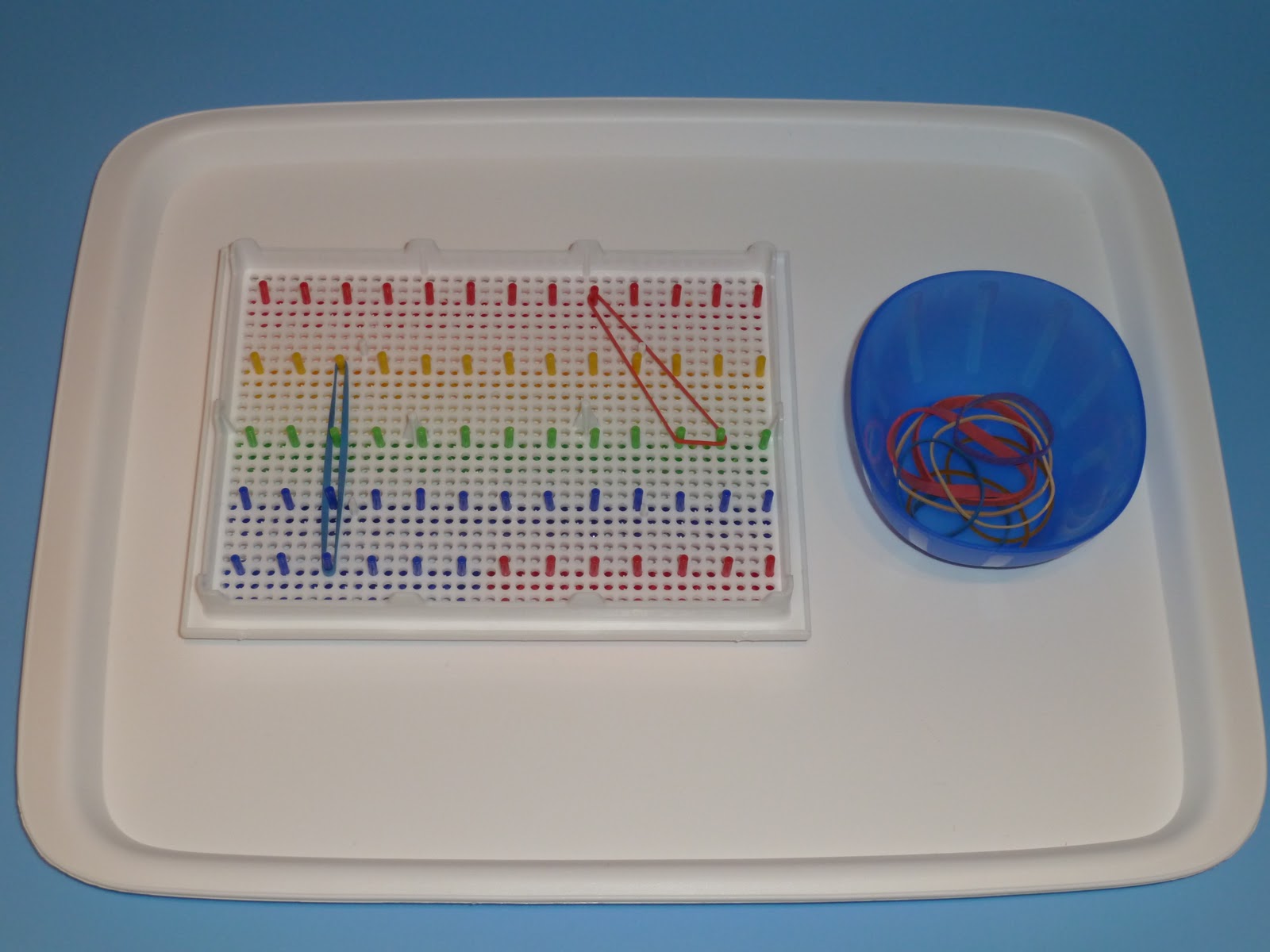 Family FECS Montessori Activity Placing Elastic Bands on Peg Board