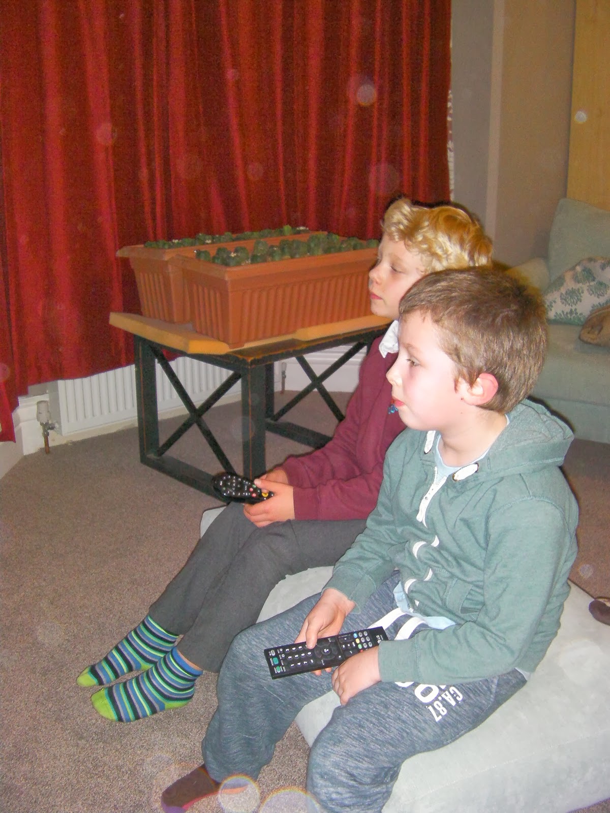 boys watching tv kids with tv remote controls