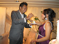 The groom feeding his new bride a piece of cake