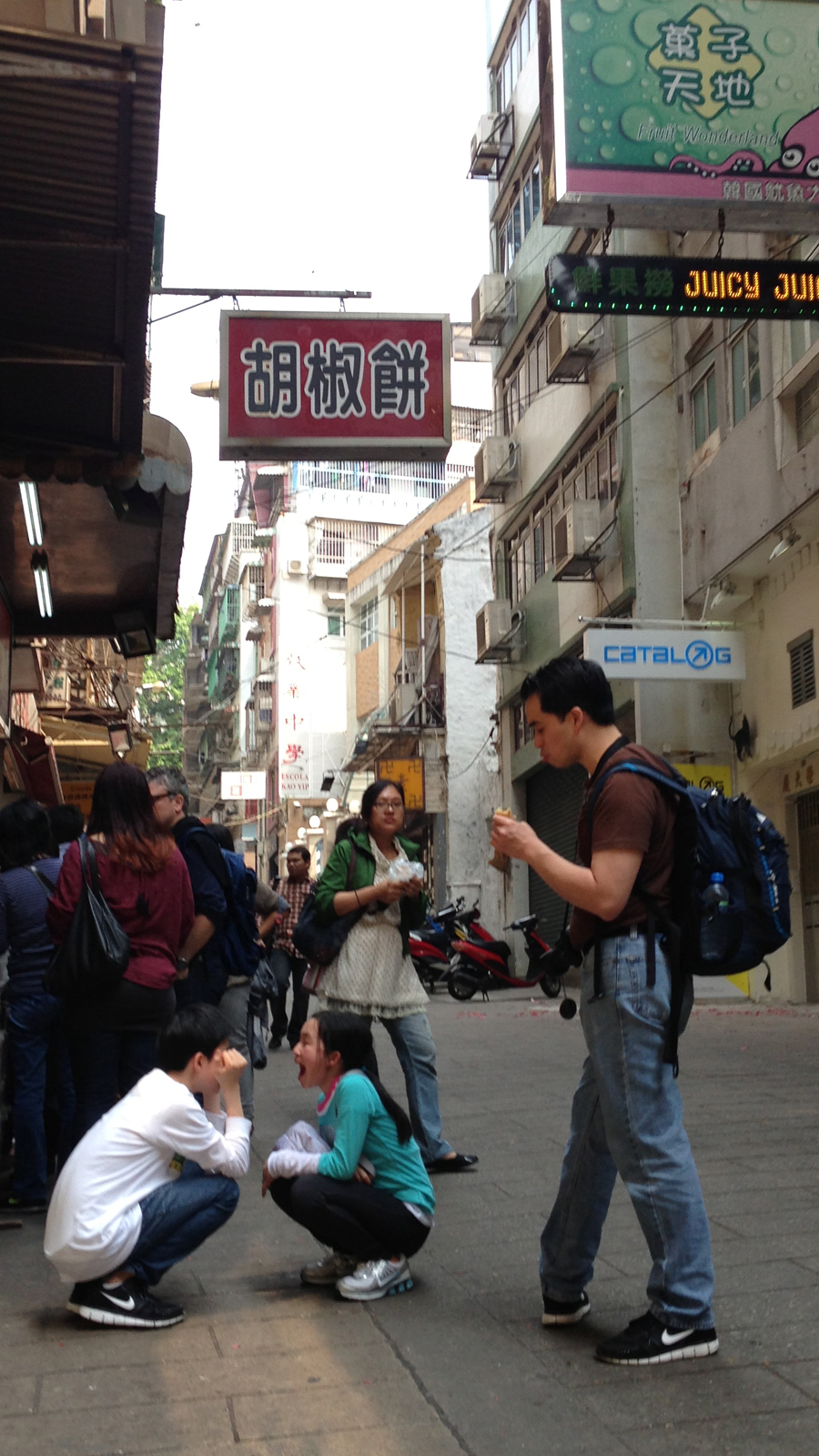 I assume they're siblings having a bit of fun near Senado Square in the Macau Peninsula.