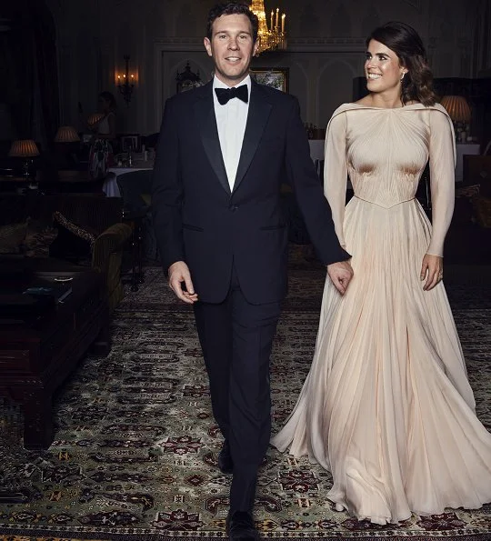 Princess Eugenie's evening dress was designed by Zac Posen, she is wearing diamond and emerald drop earrings. Princess Charlotte