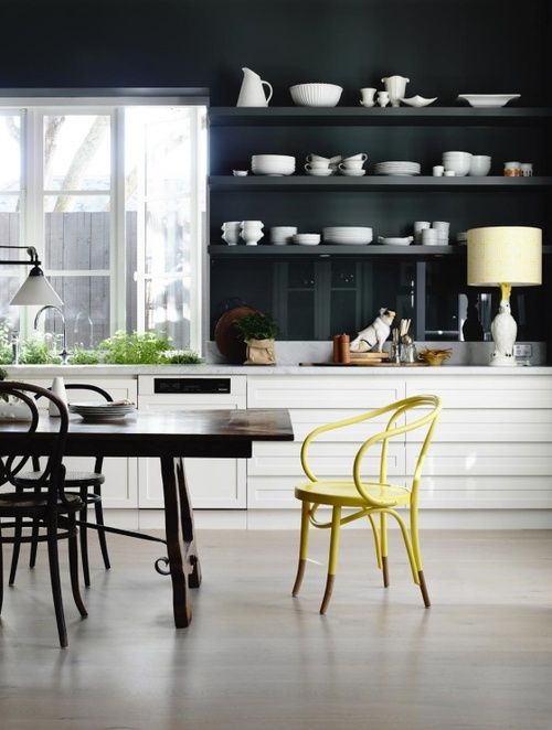 modern black and white kitchen with yellow chair