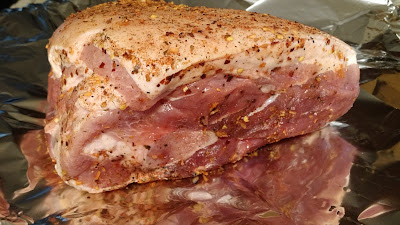 Pork shoulder seasoned and ready to be wrapped in foil.