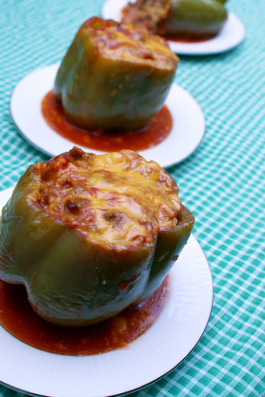 Kari's Simple Stuffed Peppers is the best stuffed peppers recipe out there!  These oven stuffed peppers are a family favorite made with ground beef, rice, and lots of cheese. #stuffedpeppers #dinner #groundbeef