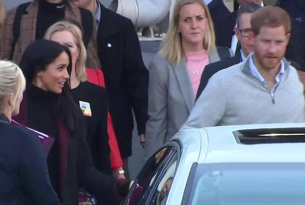 Meghan Markle wore Charcoal black and burgundy double face coat and Sarah Flint Jay tortoiseshell pumps. Prince Harry