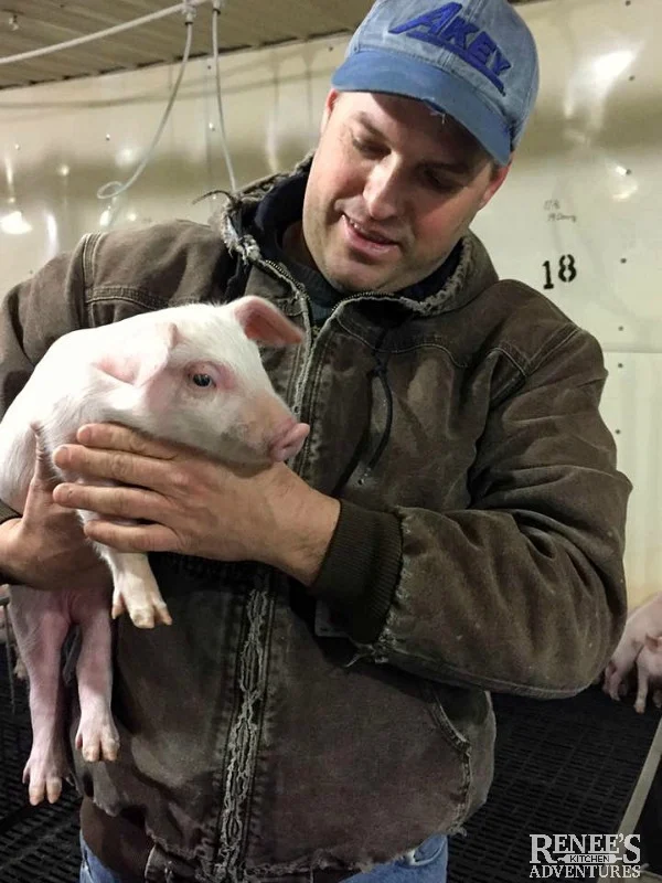 Don Shoup from Shoup Brothers Farm holding a pig