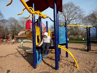 boy in hoodie mooching in recreation ground