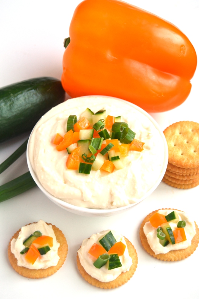 White Cheddar Horseradish Dip is ready in 5 minutes, has just 4 ingredients and is full of flavor with sharp white cheddar cheese and tangy horseradish! Topped with finely diced vegetables and served with crackers for an easy appetizer. www.nutritionistreviews.com
