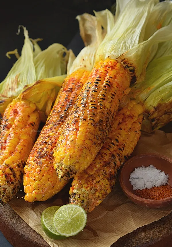 A wooden board served with Cajun Buttery Grilled Street Corn