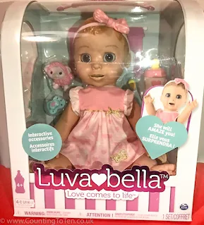 A pink luvabella doll in packaging