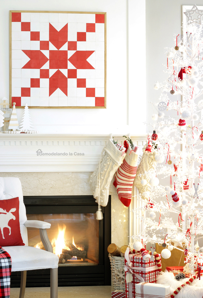 red and white wooden barn quilt with winterberry christmas tree