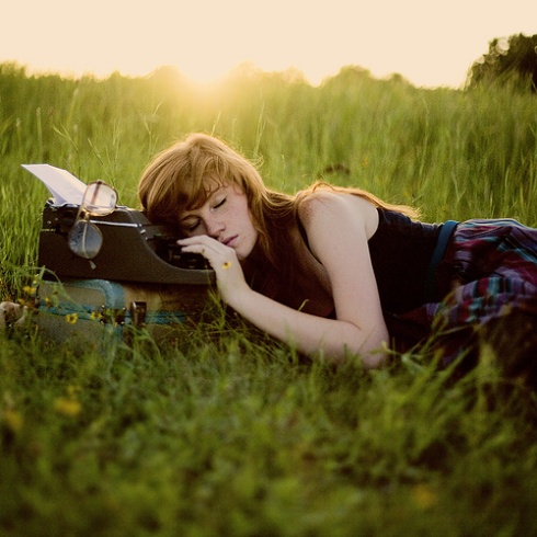 Jeune femme dormant sur sa machine à écrire.
