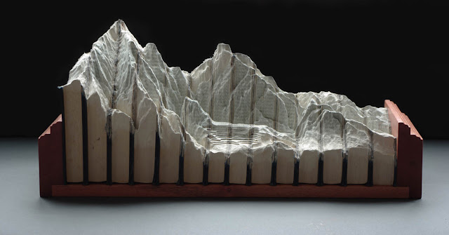 books carved into mountainscape