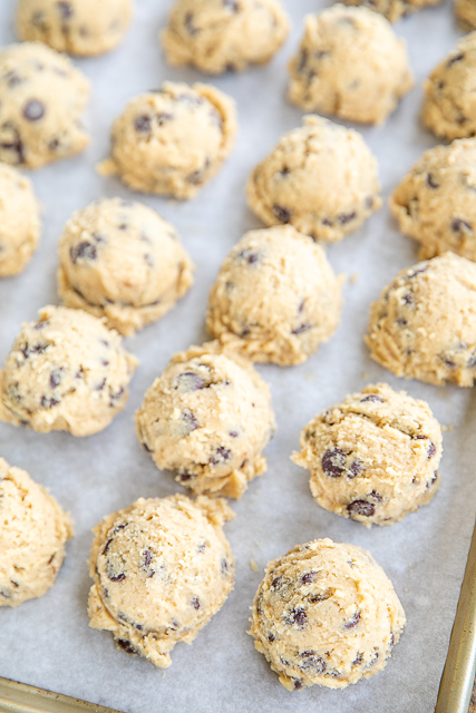 Ritz Carlton Chocolate Chip Cookies Recipe - seriously the BEST chocolate chip cookie EVER! Crispy on the outside and chewy on the inside. PERFECT! Butter, brown sugar, salt, eggs, chocolate chips, flour, vanilla, and baking powder. Can freeze cookie dough unbaked for a quick treat later. Makes a great gift too! I take these to parties and potlucks and never have any leftovers! You must make these ASAP! #cookies #chocolatechipcookies #chocolatechip cookie dough on a baking sheet