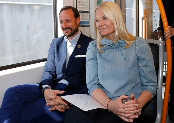 Crown Princess Mette-Marit wore ULLA JOHNSON Wes bow-embellished denim blouse. Crown Prince Haakon