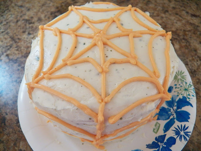 Piped web on spider cake