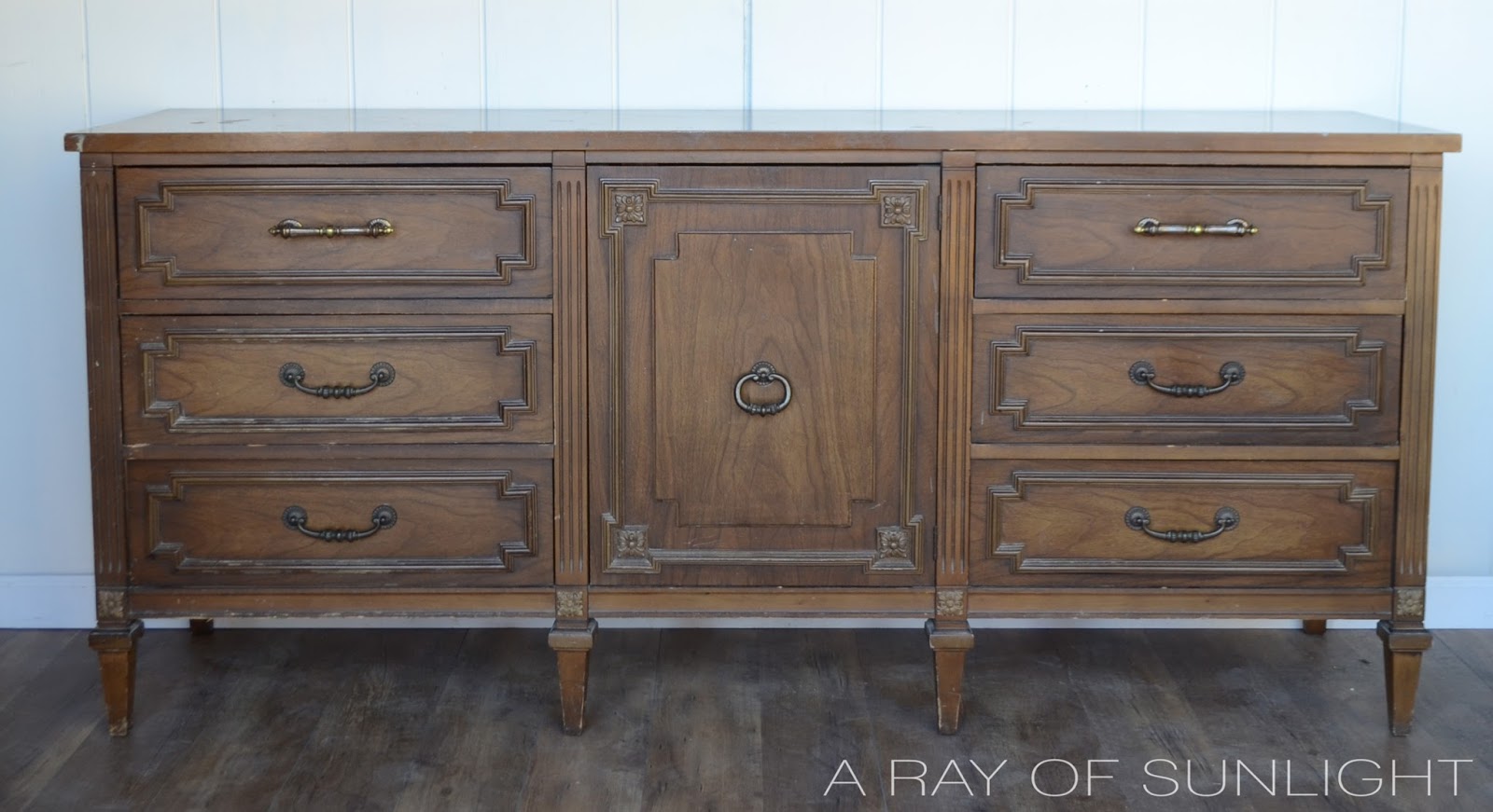 Navy blue dresser makeover into a TV stand by removing the drawers to create shelving. Then it was antiqued with glaze to deepen the color and create a unique finish. By A Ray of Sunlight #furnituremakeover #furnituretransformation #upcycledfurniture #navyfurniture #paintedfurniture #tutorial #howto #glazedfurniture #antiqued