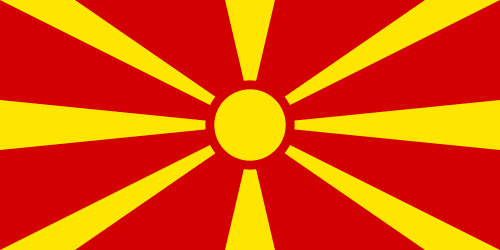 Flag of North Macedonia. A yellow sun with yellow rays radiating out from it all the way to the edges of the flag, over a blood red background, forming the impression of alternating red and yellow spokes.