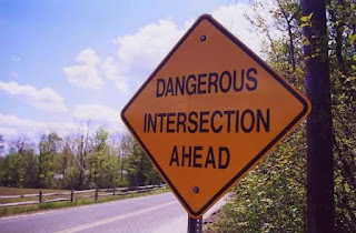 Image description: A sign that says: "Dangerous Intersection Ahead"