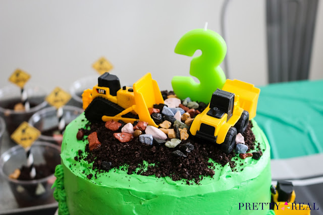 easy construction themed birthday cake with dirt, rocks, and trucks