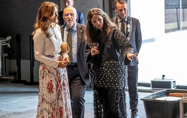 Crown Princess Mary wore a new pleated scarf print skirt by Paul and Joe. Elise Gug silk blouse, Naledi Copenhagen clutch