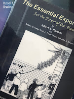 The Essential Exponential! For the Future of Our Planet, by Albert Bartlett, superimposed on Intermediate Physics for Medicine and Biology.