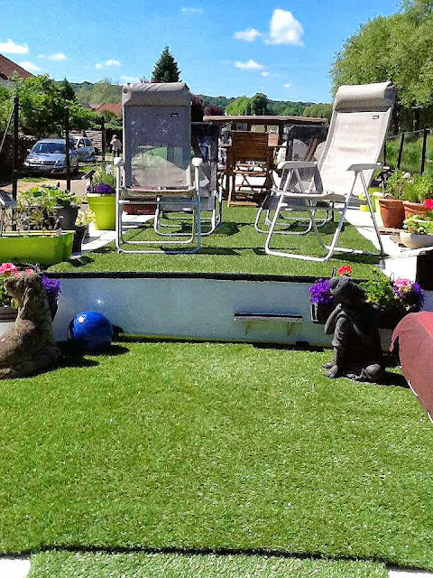 A large area of deck garden with beautifully soft AstroTurf, lounges, deck chairs, a giant beanbag and an outside table with six chairs for al fresco dining.