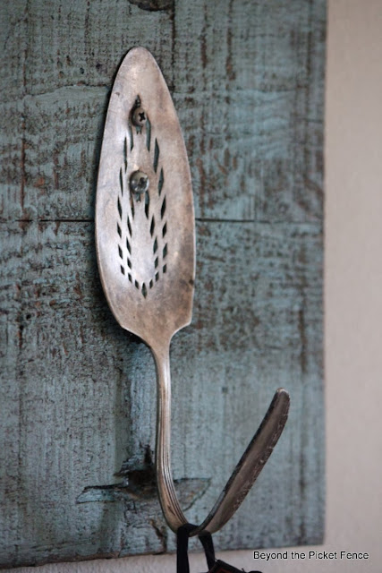 Repurposed Junk Coat Hook using a potato masher, pulley, trowel, door loock and cake server as hooks with reclaimed wood http://bec4-beyondthepicketfence.blogspot.com/2014/01/repurposed-junk-coat-hook.html