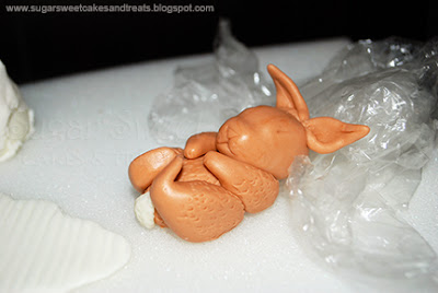 Closeup of hand sculpted baby bunny made from fondant.
