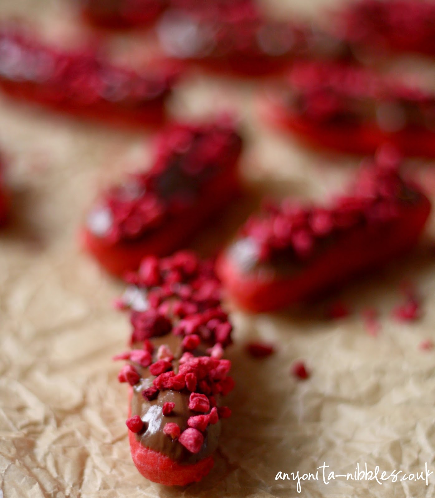 Freezedried raspberries on top of a mini gluten free red velvet eclair from Anyonita-nibbles.co.uk