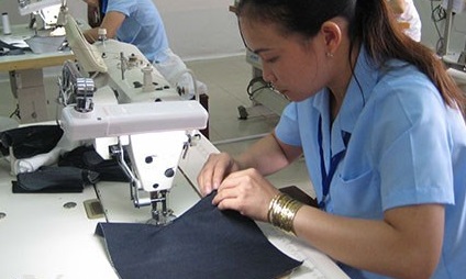 công nhân đang may sản phẩm từ vải jean