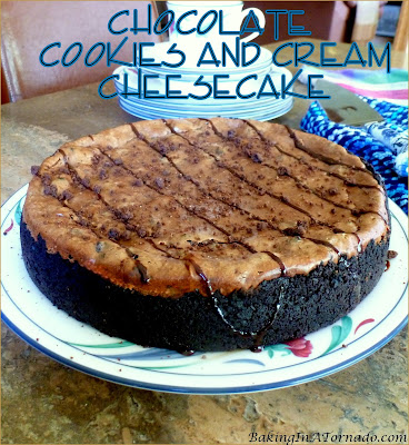 A Chocolate lover’s favorite, Chocolate Cookies and Cream Cheesecake marries a dense chocolate cheesecake studded with cookie chunks with a cookies and cream crust. | Recipe developed by www.BakingInATornado.com | #recipe #chocolate