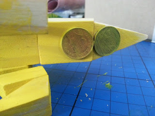 Adding pennies to wooden model for balance