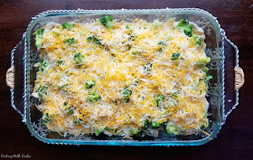 9x13 pan loaded with pasta, chicken, eggs and cheese ready to bake into a casserole