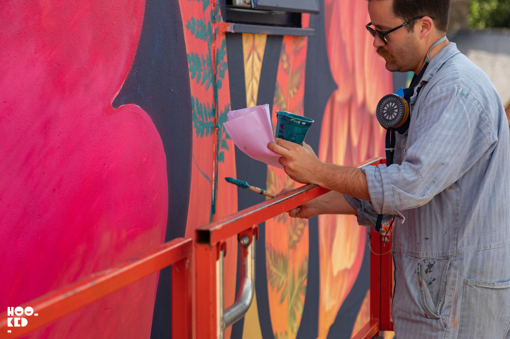 US artist Beau Stanton at work on his mural in Walthamstow, London