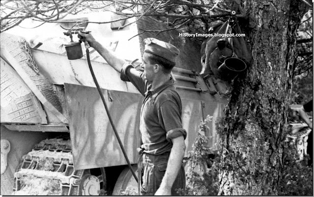 A German soldier gives a Jagdpanther a fresh coat of paint