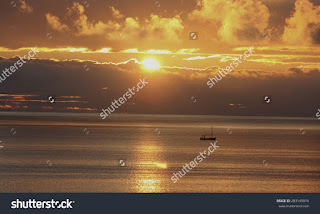 dawn in Ibiza,fishermen out at dawn in his fishing boat on a sunny day with some clouds on the horizon, golden yellow sun and golden sun wake in the sea,small waves on a calm Mediterranean Sea dawn in Ibiza,fishermen out at dawn in his fishing boat on a sunny day with some clouds on the horizon, golden yellow sun and golden sun wake in the sea,small waves on a calm Mediterranean Sea