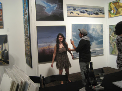 Couple posing in front of Katherine Kean's painting Spooky Action at the Palm Springs Fine Art Fair, Izen Miller Gallery - Booth 211