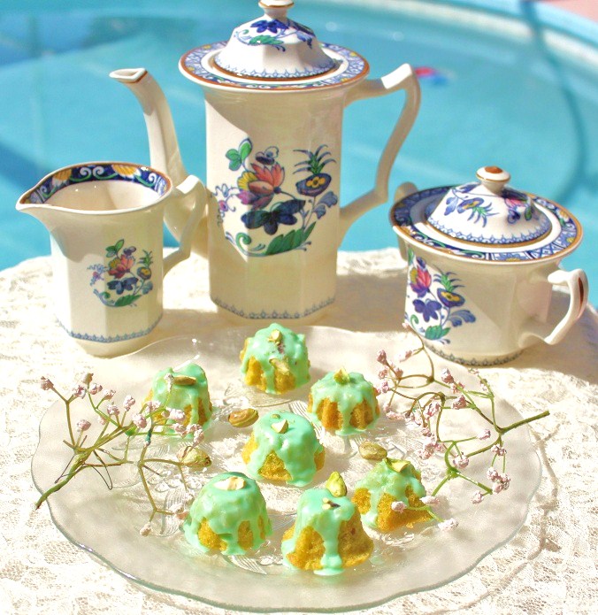 grandma's tea set Little pistachio tea cakes with frosting, flowers on a antique plate