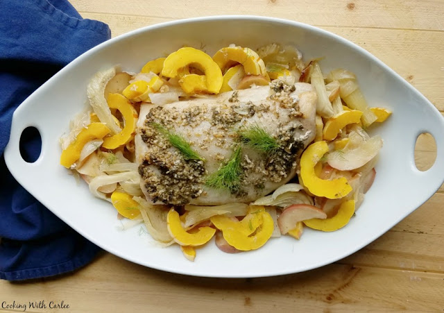 A simple but delicious pork loin cooked with apples, fennel and fall vegetables. You are going to love the slightly sweet and savory combination that puts dinner on the table in one pot. serving platter filled with roasted squash, fennel, onions, apples and pork loin ready to serve