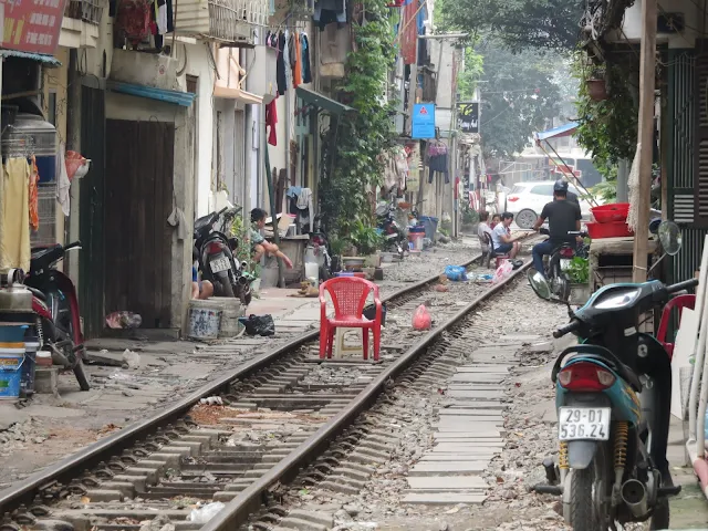 Red plastic chair on train tracks in Hanoi Vietnam