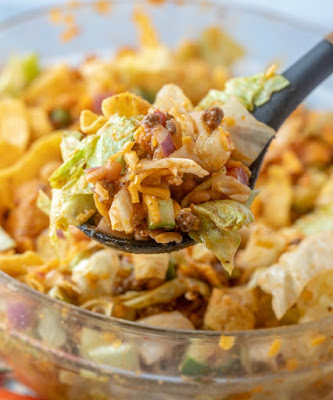 serving spoon full of frito taco salad