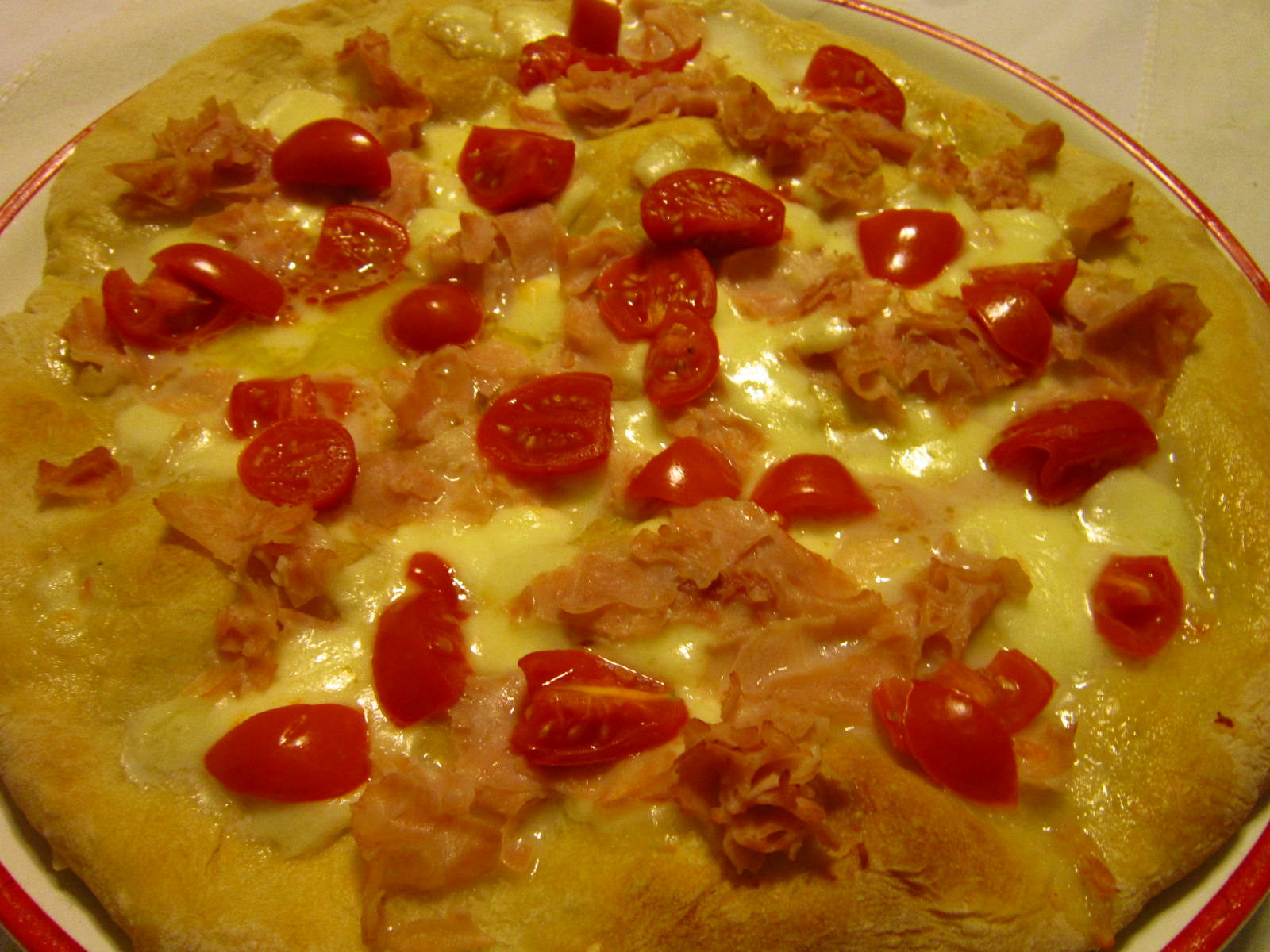 Pizza con mozzarella, prosciutto cotto e pomodorini