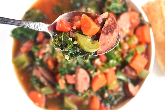 Smoky Sausage, Kale and Quinoa Soup is the perfect hearty, nutritious soup that is full of flavor and spice that your family will love! www.nutritionistreviews.com