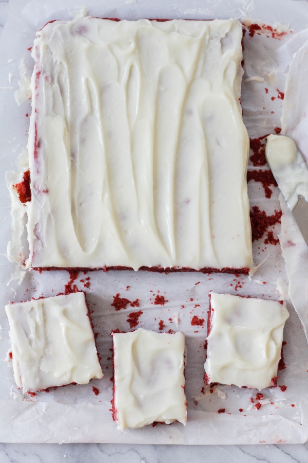 These decadent Red Velvet Bars are covered in a delicious Cream Cheese Frosting and are so simple to make! They are the perfect treat for your loved ones on Valentine's Day, or just when you want to spread some love.